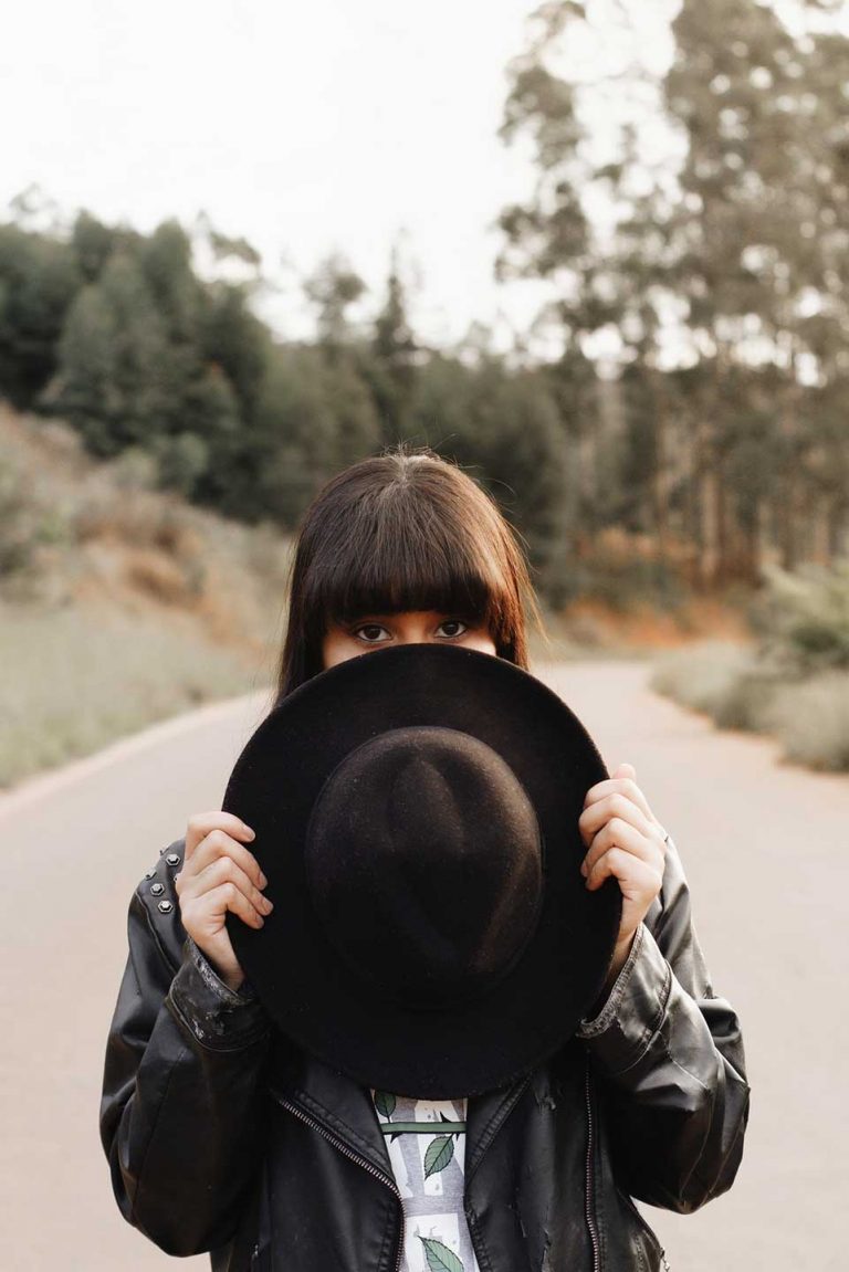 Girl covering her face with hat